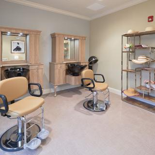 Modern hair salon interior with styling chairs and mirrors.
