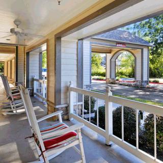 A quaint porch with rocking chairs offers a relaxing spot to enjoy the outdoor view.