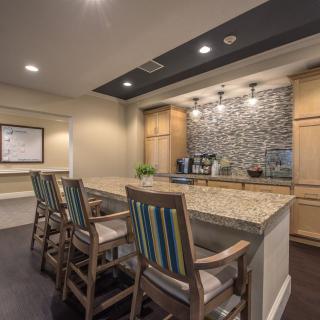 Modern kitchen with granite countertops and bar seating.