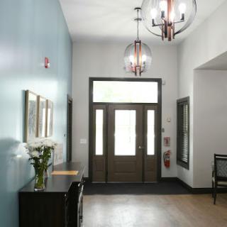 A modern entrance lobby featuring stylish chandeliers and a welcoming atmosphere.