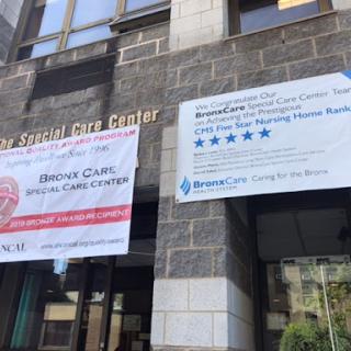 Exterior view of a healthcare facility featuring banners for an urgent care center and additional services.