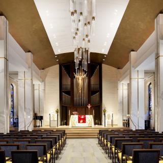 A modern church interior featuring a grand chandelier and sleek architectural design.