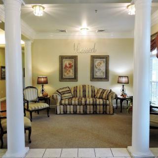 Elegant living room with classic furniture and decorative artwork.