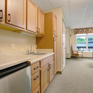A cozy kitchen area featuring wooden cabinets and a view outside.