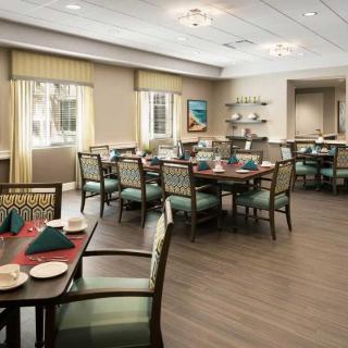 An elegantly decorated dining room with neatly arranged tables and chairs, ready for guests.