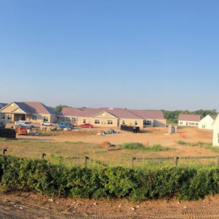 Suburban housing development under construction on a clear day.
