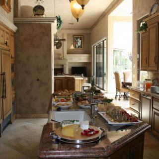A spacious kitchen with a central island and dining area.