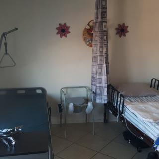 A hospital room with two beds and medical equipment.