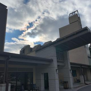A modern building under a cloudy sky.