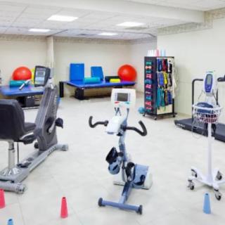 A well-equipped gym with various exercise machines and fitness accessories.