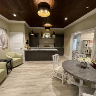 A modern kitchen interior featuring an island counter and cozy seating area.