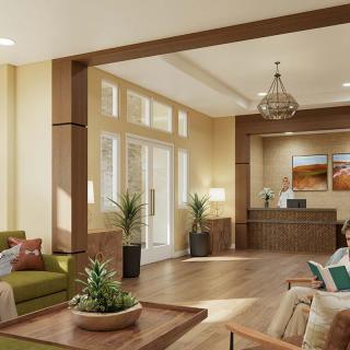 A modern lobby area featuring comfortable seating, decorative plants, and warm lighting.