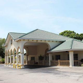 A view of a commercial building with a distinctive roof and arched entrance.