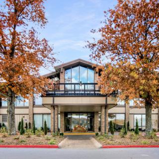 A hotel entrance surrounded by autumn trees.