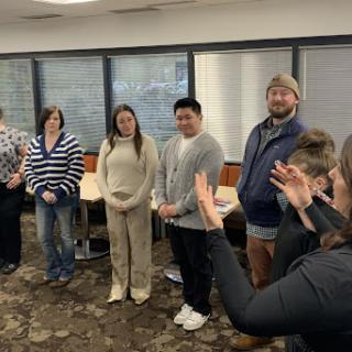 A diverse group of individuals engaged in a discussion during a meeting.