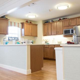 A modern kitchen with wooden cabinets and stainless steel appliances.