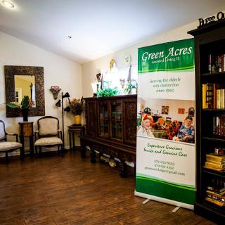 A cozy interior space featuring a seating area, decorative furniture, and a promotional banner.
