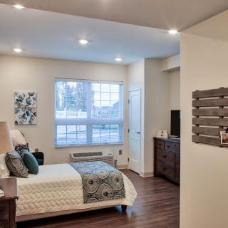 A modern and cozy bedroom with stylish decor and natural light.