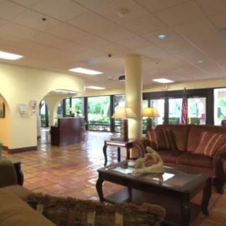 A spacious hotel lobby featuring comfortable seating and a welcoming reception area.