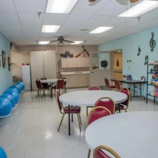 A classroom with tables, chairs, and exercise balls in an educational setting.