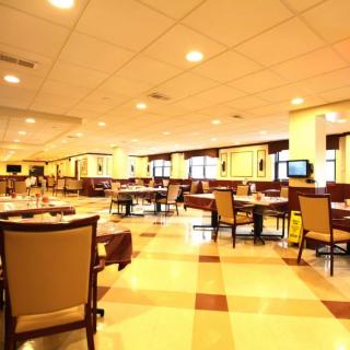 Spacious restaurant interior with neatly arranged tables and chairs.