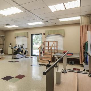 A rehabilitation room equipped with exercise apparatus and therapy tools.