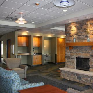 A welcoming lobby area featuring a stone fireplace and comfortable seating.