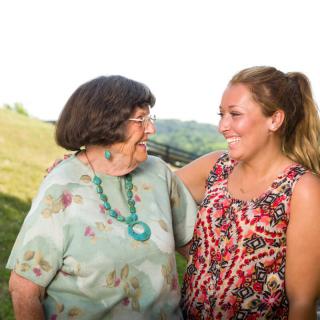 A joyful moment between two women sharing a connection outdoors.