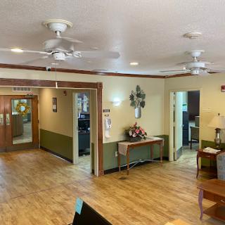 A welcoming lobby featuring ceiling fans and a warm wooden floor, perfect for relaxation.