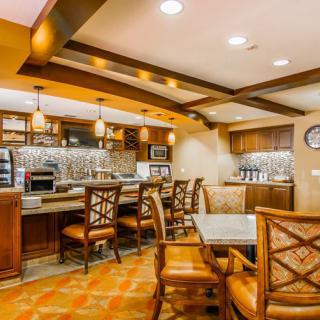 Cozy restaurant interior with wooden furniture and warm lighting.