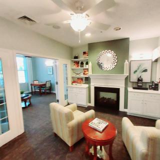 A cozy living room with a modern fireplace and comfortable seating.