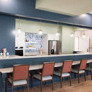 Modern kitchen interior with a bar counter and seating area.