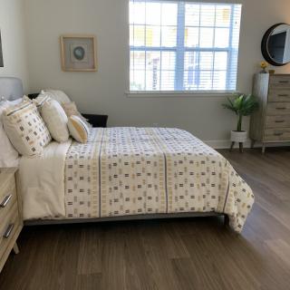 A cozy, minimalist bedroom with natural lighting and modern decor.