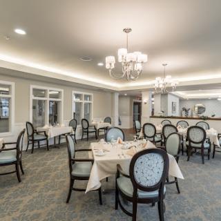An elegant dining room setup featuring tasteful decor and spacious seating.