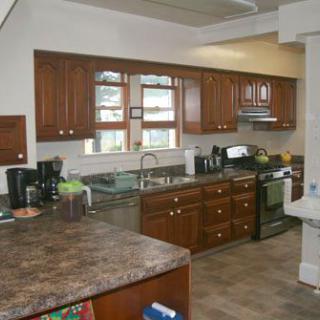 A modern kitchen with wooden cabinets and various appliances.