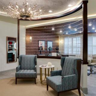 A stylish and inviting reception area featuring modern furniture and elegant lighting.