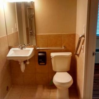 A small bathroom with a sink and toilet next to each other.