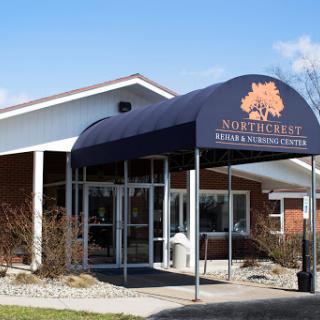 The entrance of a healthcare center featuring a prominent canopy and welcoming signage.