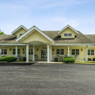 A suburban residential building with an inviting entrance and a driveway.