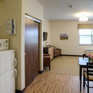 A well-organized living space with a kitchenette and dining area.