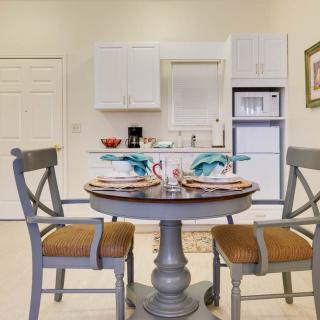 A cozy dining area with a round table set for two, nestled in a compact kitchen space.
