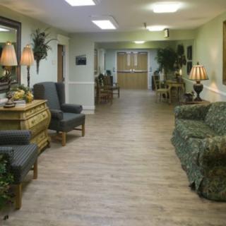 A cozy hallway with seating and decorative elements.