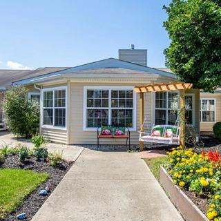 A charming house with a well-maintained garden and colorful flowers.