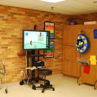 A therapy room equipped with exercise equipment and rehabilitation tools.