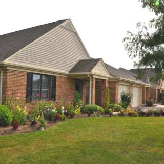A suburban house with a well-maintained lawn and garden.