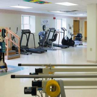 A spacious rehabilitation center equipped with various fitness machines.