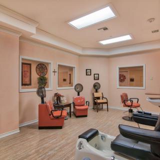 A cozy salon interior with chairs, hair dryers, and mirrors, creating a welcoming waiting area.