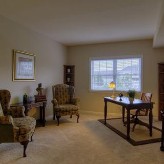 A cozy living room with elegant furniture and a window providing natural light.