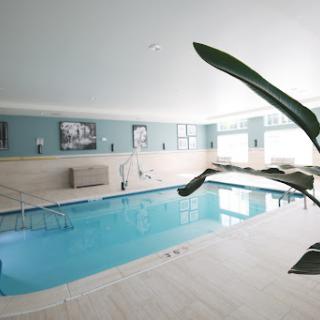 A serene indoor swimming pool with modern decor, perfect for relaxation and fitness.