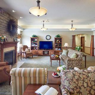 A cozy living room with a fireplace, TV, and comfortable seating.